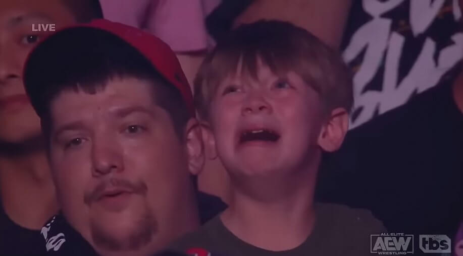 Crying child in wrestling crowd