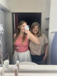 a mom and daughter taking a mirror selfie